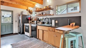 A modern kitchen with wooden cabinets, a stainless steel refrigerator, and a wooden countertop. - Snow Daze! Visit the mountains! Bring your pup, stay, play & enjoy clean air! (Big Bear)