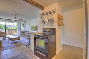 Enjoy cooking in the kitchen with a stainless steel stove, double oven, and microwave, plus a view of the outdoors.