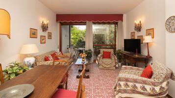 Family Apartment, 4 Bedrooms | Living area | Flat-screen TV