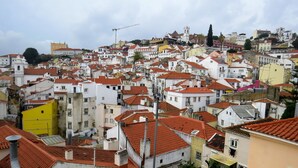 Una zona urbana densa con edifici vicini tra loro, una chiesa imponente e una gru edile.