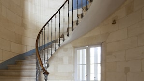 A grand staircase with a marble floor and a classic design.