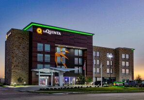 A hotel with a modern design, featuring a prominent logo and a large entrance. - La Quinta Inn & Suites by Wyndham Terrell (Terrell)