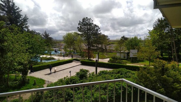A courtyard with a pool, surrounded by trees and a small building. - 2 room vacation apartment Strandpromenade Sankt Peter Ording (Sankt Peter-Ording)