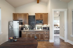 Fridge, microwave, coffee/tea maker, cookware/dishes/utensils