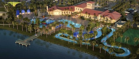 A resort with multiple swimming pools, a dock, and a large building with a red roof.