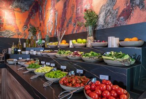 A buffet with various food items and a decorative wall. - Levor Hotel (Bursa)