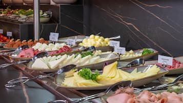 A buffet with various food items and utensils.