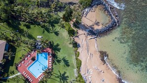 An aerial view of a resort with a swimming pool, beach, and palm trees. - Lae Nani 434 1 Bedroom Condo by RedAwning (Kapaa)