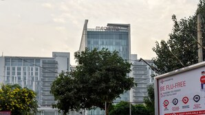 A modern building with the 'medanta' logo and a sign promoting flu shots.