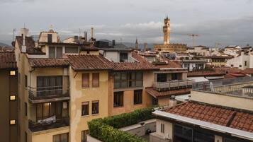 A residential area with multiple buildings, some with balconies and tiled roofs.