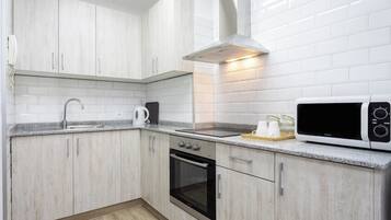 Een magnetron, een oven, een kookplaat, een koffiezetapparaat/waterkoker