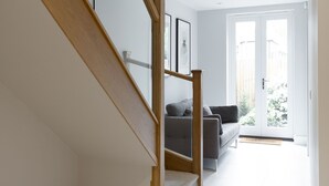 Un intérieur moderne avec un escalier en bois menant à un espace de vie.