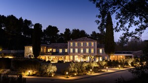A large, multi-story building with a classic architectural style, featuring a central courtyard and multiple windows. - Domaine de Valmouriane (St.-Rémy-de-Provence)