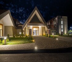 L’entrée d’un hôtel au design moderne, avec une entrée centrale flanquée de deux ailes.