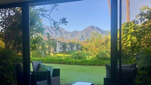 A room with a view of a landscaped garden and mountains. - Mamalahoa Mountain View Luxury Condo (Princeville)