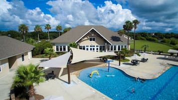 Relax by the inviting pool surrounded by a spacious patio and beautifully landscaped lawn.