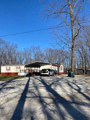 Large driveway with covered parking.