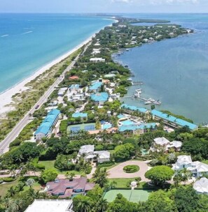 An aerial view of a coastal resort with multiple buildings, a beach, and a marina. - Captiva Tarpon (Captiva)