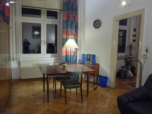 Cozy living space with a dining area, sofa, and window.