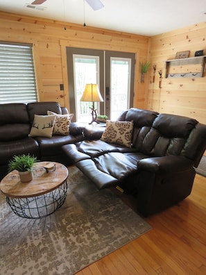 Relax in this inviting living room with a comfortable sofa, coffee table, and plant.