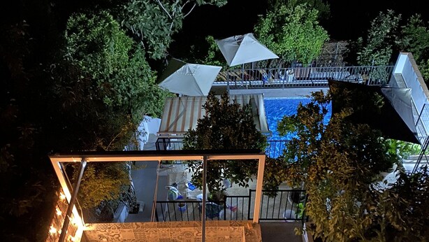 A rooftop terrace with a dining area, a pool, and a staircase leading to the upper level. - Beautiful House With Fantastic Views of the Sierra (Grazalema)