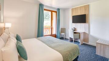 A hotel room with a bed, a desk, a chair, a TV, and a balcony.