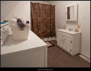 Bathtub, towels, soap, toilet paper