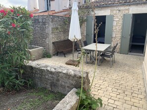 Relax in a serene outdoor space surrounded by lush greenery and a tranquil atmosphere.