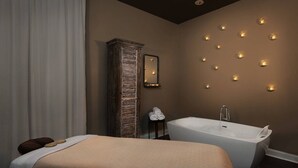 A modern bathroom with a freestanding bathtub, a large mirror, and wall-mounted lights. - Marriott's Ocean Front Barony Beach Club Resort Hilton Head, SC (Hilton Head Island)