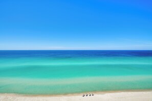 A beach with clear turquoise water and a sandy shore. - Ocean View Condo Btwn Rosemary & Alys Beach! (Rosemary Beach)
