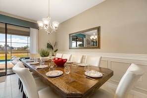 Enjoy meals in this dining area with a large table and comfortable seating for all.