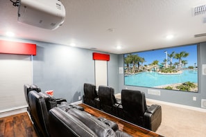 A conference room with a large window overlooking a pool and palm trees. - Exceptional Villa: Saltwater Pool, No Rear Neighbors, Game Room & Movie Theater (Davenport)