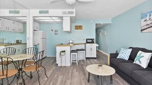 A compact living space with a kitchenette, dining area, and seating area. - Direct Oceanfront condo- AMAZING VIEWS & GREAT AMENITIES! (Ocean City)