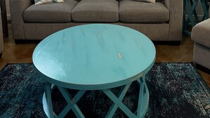 A living room with a grey sofa, teal coffee table, and teal side tables. The wall features a 'HOME' sign and various decorative items. - Seas the day! Freshly updated 3/2 with ability to sleep 10 available! (Port Aransas)