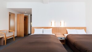 A hotel room with a large bed, two bedside tables, a chair, and a wardrobe. - The OneFive Osaka Sakaisuji (Osaka)