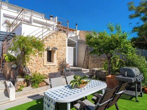 A patio with a table, chairs, and a grill. - Can Rochet by Interhome (Alaró)