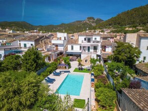 A residential area with a swimming pool surrounded by greenery and buildings. - Can Rochet by Interhome (Alaró)