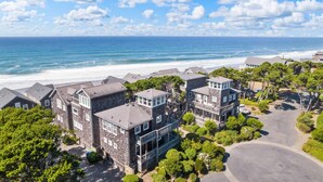A coastal residential area with multiple two-story houses, a beach, and a clear sky. - Wonderful Coastal Retreat, Open Layout, Steps Away From Beach, Fireplace, BBQ, Ocean Views (Depoe Bay)