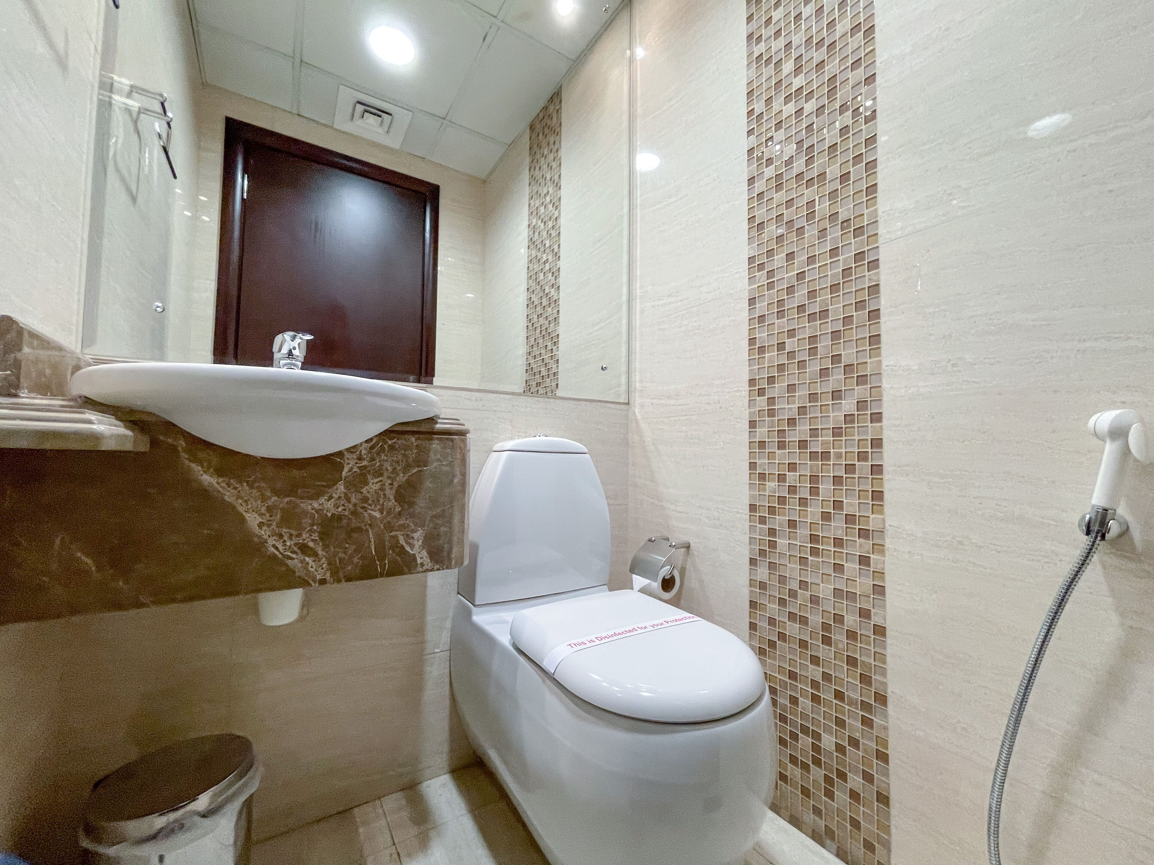 A bathroom with a sink, toilet, and shower.