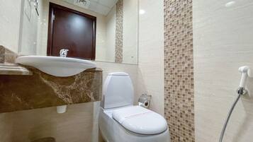 A bathroom with a sink, toilet, and shower.