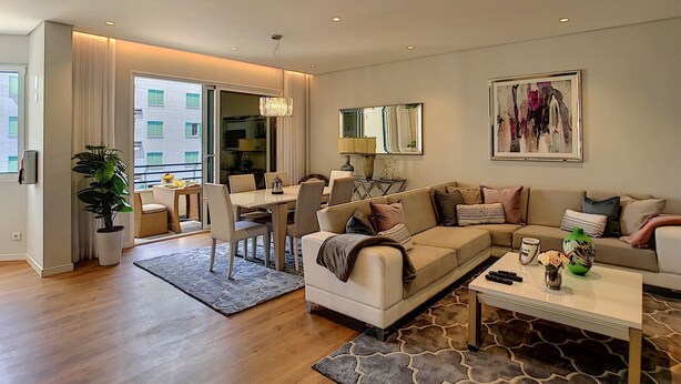 A modern living room with a sofa, coffee table, and dining area. - Paradise Apartment by LovelyStay (Funchal)