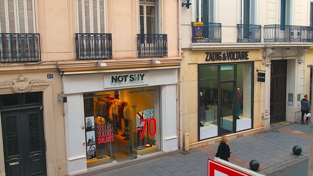 Storefronts of 'Not Shy' and 'Zadig & Voltaire' with mannequins displaying clothing. - 140 Rue D'antibes (Cannes)