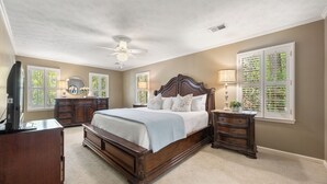 A bedroom with a large bed, a dresser, a nightstand, and a ceiling fan. - Big Beds for Everyone!  Braves Stadium only 2.5 miles away! (Marietta)