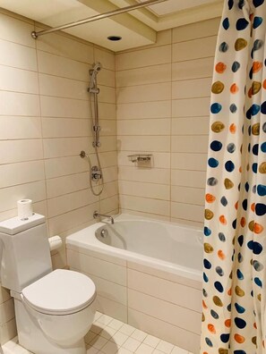 A bathroom with a toilet, bathtub, and shower. - Downtown dubai views (Dubai)