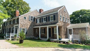 A two-story house with a front porch, a chimney, and a small attached garage. - Historical Bed and breakfast<br> (Water Mill)