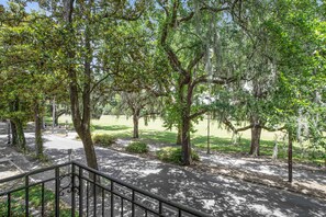 A park with trees, a paved walkway, and a railing. - Oasis Overlooking Forsyth Park w/ Private Balcony & Parking by Lucky Savannah (Savannah)