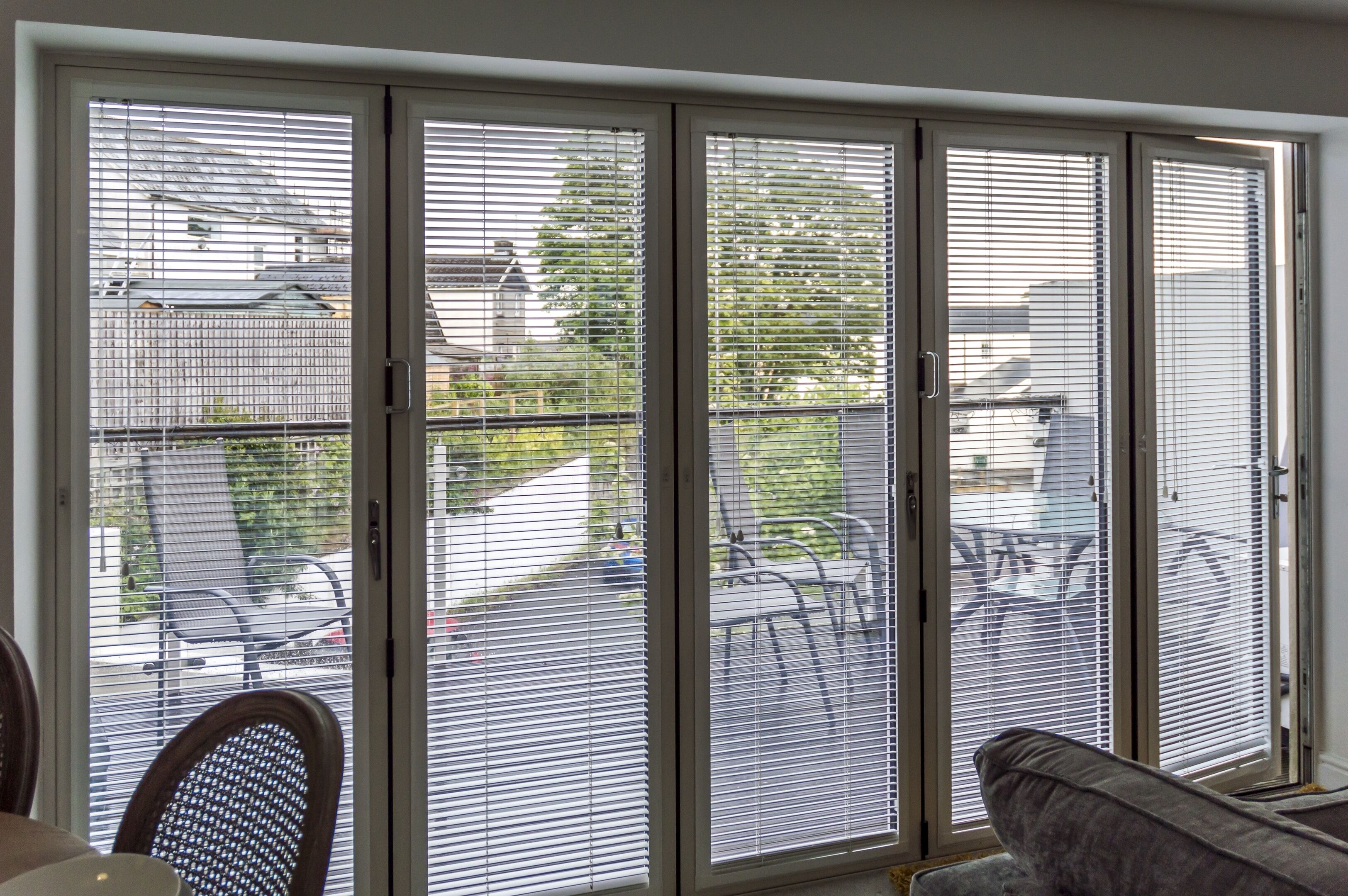 A room with a sliding glass door leading to an outdoor patio area.