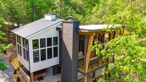 A modern two-story house with a large deck, surrounded by trees. - New/Modern Rustic/Mins. to Blue Ridge/Spacious/Hot Tub (Mineral Bluff)