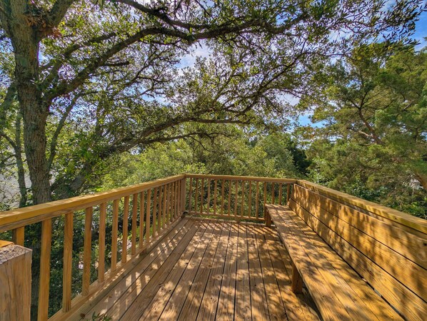 A wooden deck with railings, surrounded by trees. - Longs for the Sea - North Litchfield Beach (Pawleys Island)