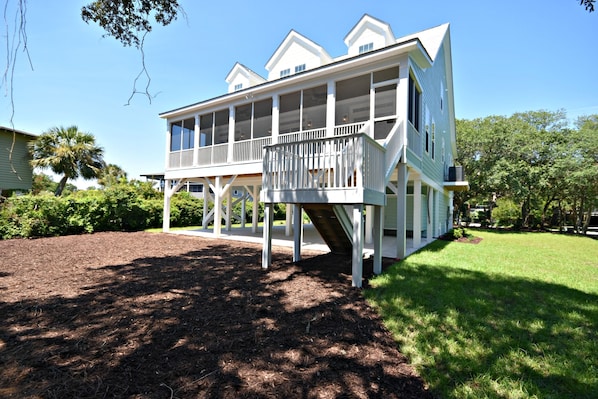 A two-story house with a balcony and a small porch.